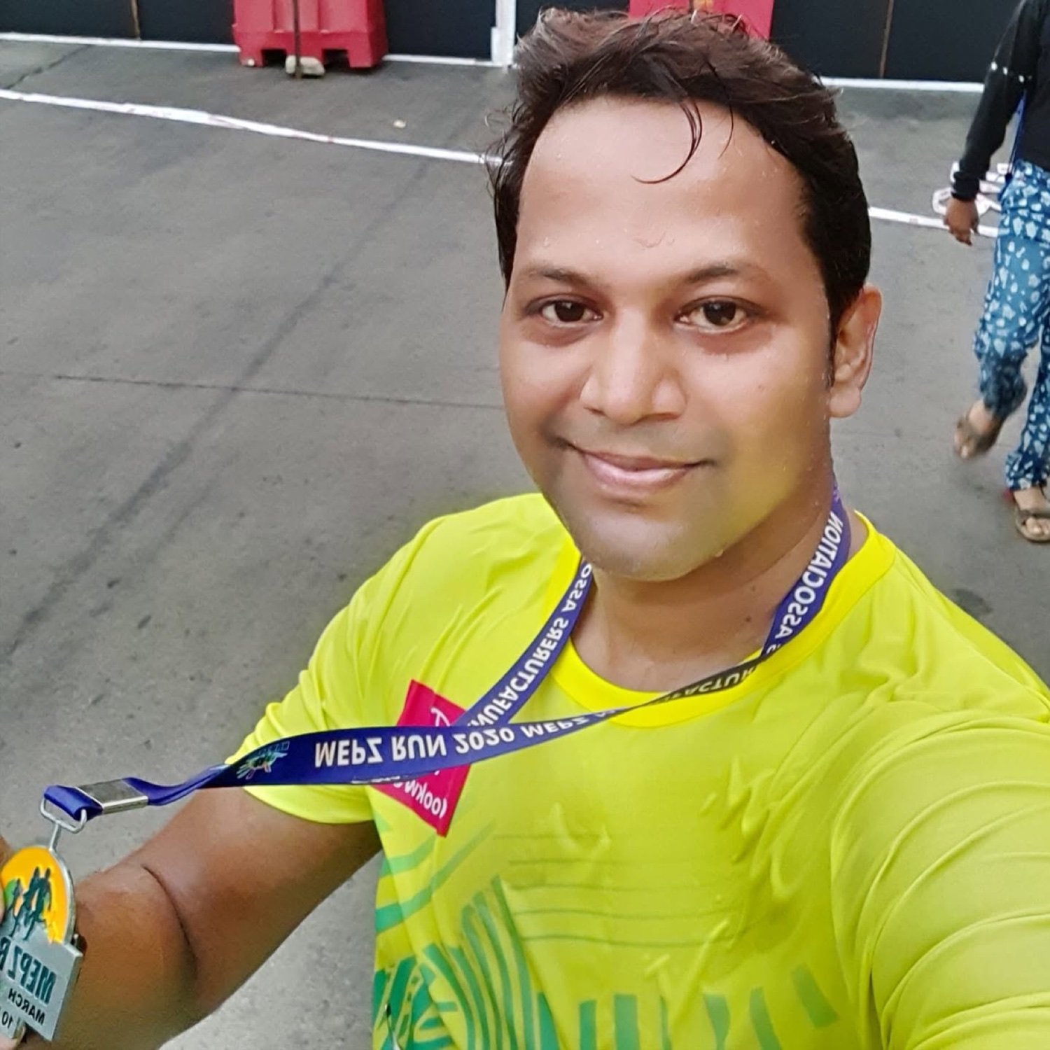 Gurushankar after a run, holding a medal
